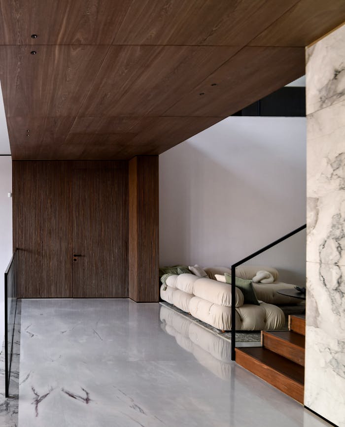 Elegant interior with marble and wood elements in a minimalist style.